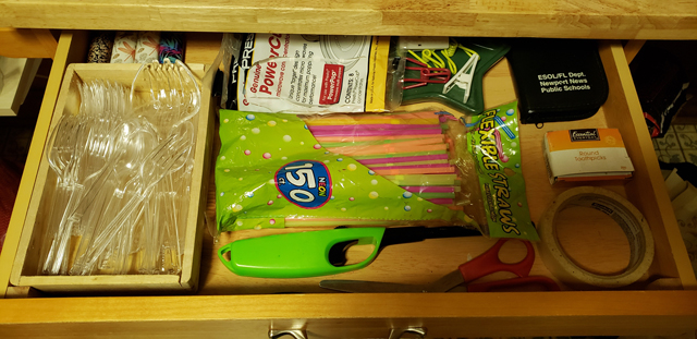 A drawer with a single layer of kitchen-appropriate items like scissors, tape, straws, and bag clips