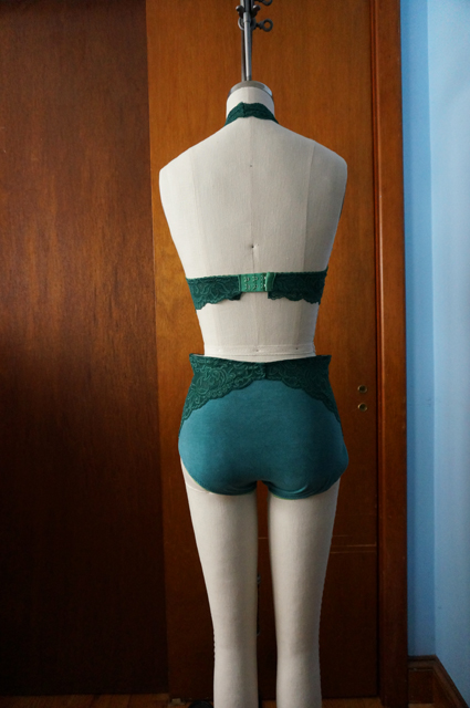 Back view of dress form displaying a lace halter bralette and high-waisted underwear with lace side panels