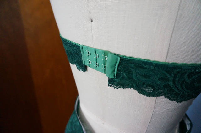 Close-up of the hook and eye closure on a lace halter bralette